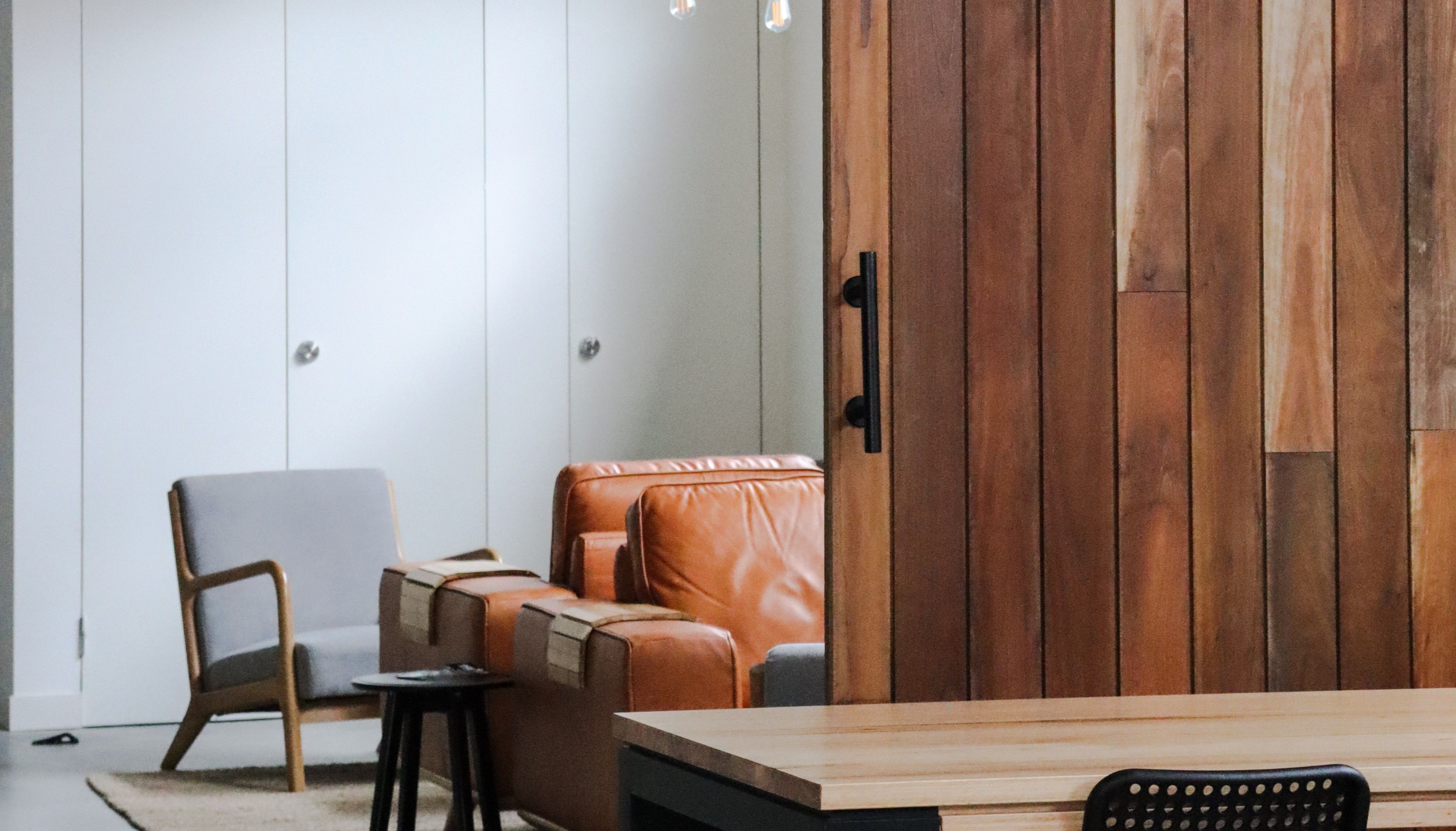 Hotel interior with couches and a timber door